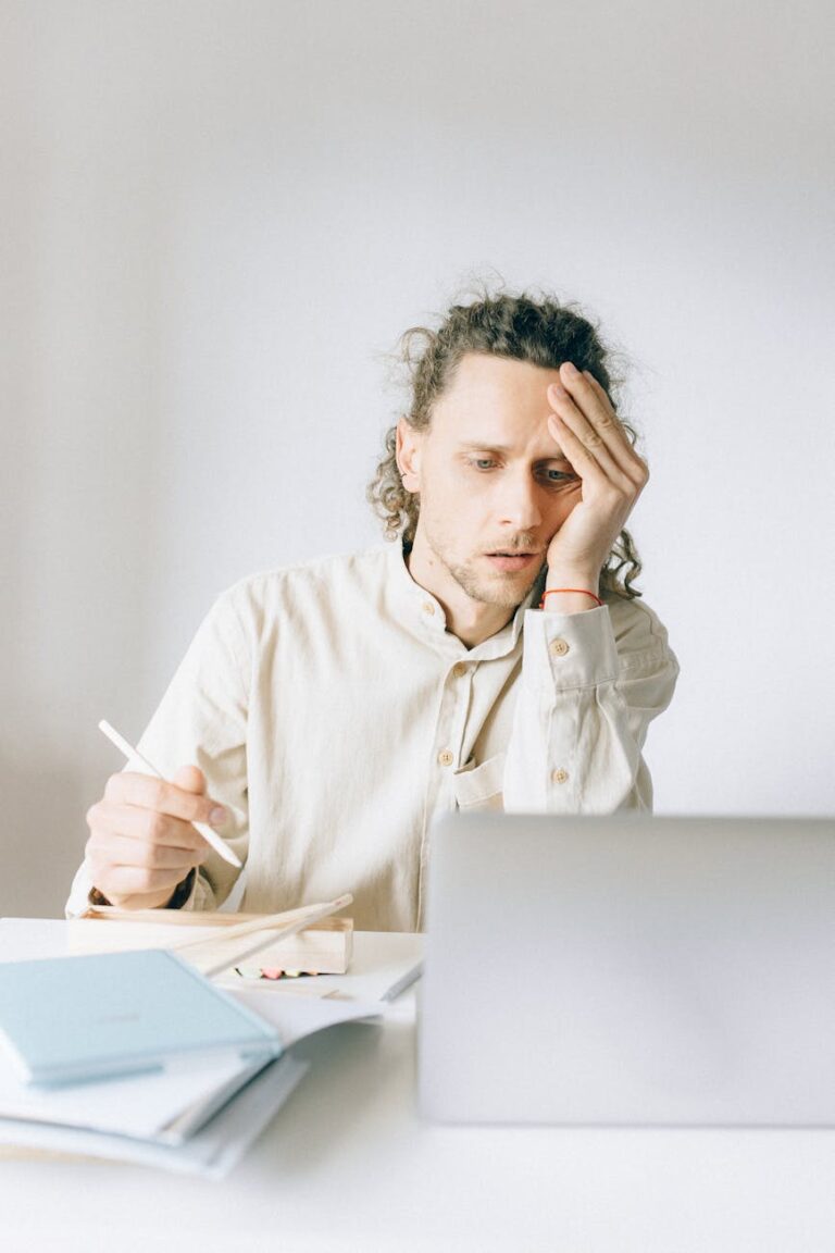 woman in white dress shirt sitting by the table